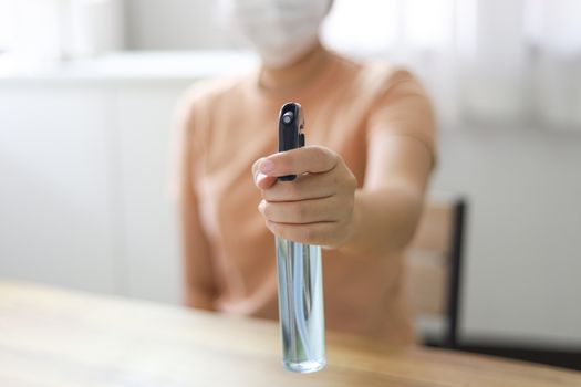 Woman spraying alcohol Anti-Bacterial Sanitizer disinfectant spray to prevent Coronavirus or Covid-19