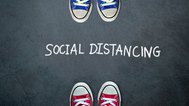 Social distancing. two people keep spaced between each other for social distance, increasing the physical space between people to avoid spreading illness during transmission of COVID-19 outbreak