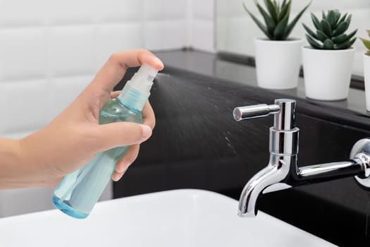 disinfect, sanitize, hygiene care. people using alcohol spray on faucet , hydrant and frequently touched area for cleaning and prevention of germs spreading during infections of COVID-19