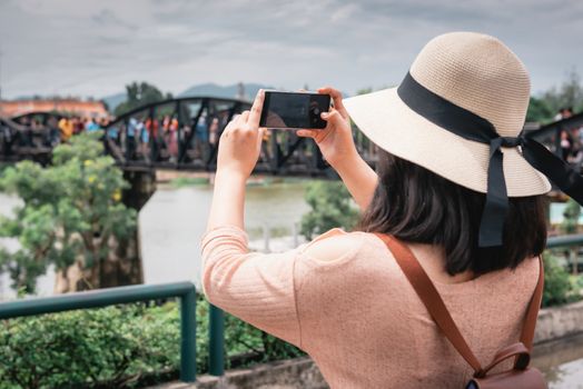 Tourist Woman Having Fun While Sightseeing in Travel Place, Asian Woman Relaxing and Enjoyment While Photographing Landmark of Ancient Architecture in Thailand. Travel Exploring and Journey Concept