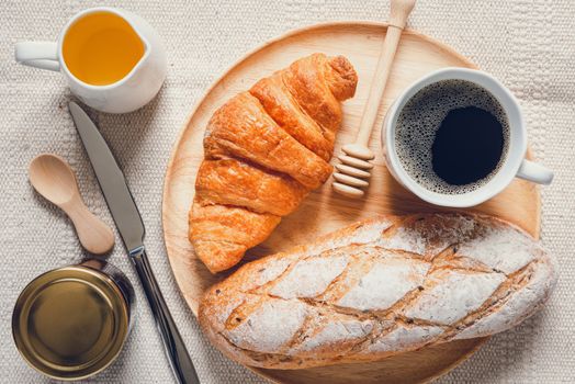 Traditional Breakfast Natural Vegetarian Food With Sourdough Bread, Coffee, Honey, Croissant on The Table., Homemade Freshly Baked French Sourdough Loaf for Breakfast. Food and Beverage Concept