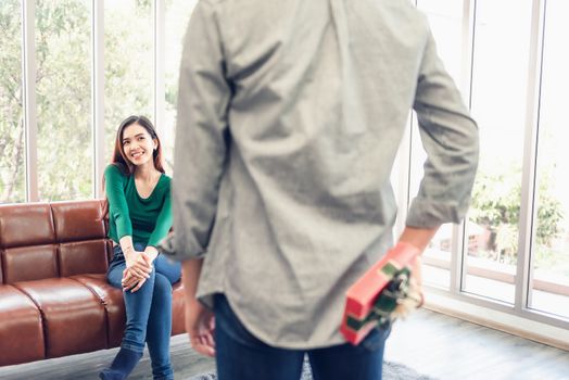 Romantic Surprise and Couple Love Valentine Concept, Young Man is Presenting Surprised to His Girlfriend at Home. Beautiful Woman Having Happiness and Surprise While Her Boyfriend Giving Presents Box.