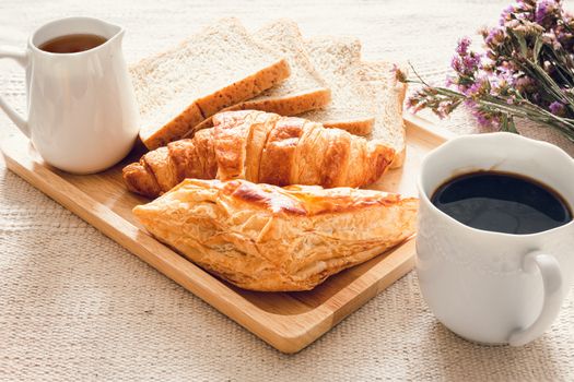 Traditional Breakfast Natural Vegetarian Food With Sourdough Bread, Coffee, Honey, Croissant on The Table., Homemade Freshly Baked French Sourdough Loaf for Breakfast. Food and Beverage Concept