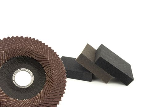 Set of different tools for grinding - flap disc for angle grinder and abrasive sponges , isolated on white background