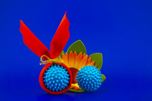 Corona virus models wrapped as gifts and Easter eggs on a blue background with copy space