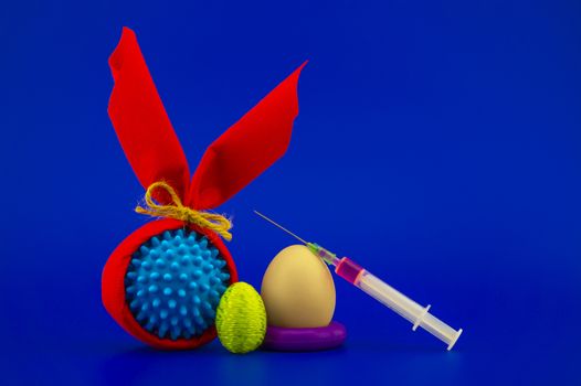 Corona virus models wrapped as gifts and Easter eggs on a blue background with copy space