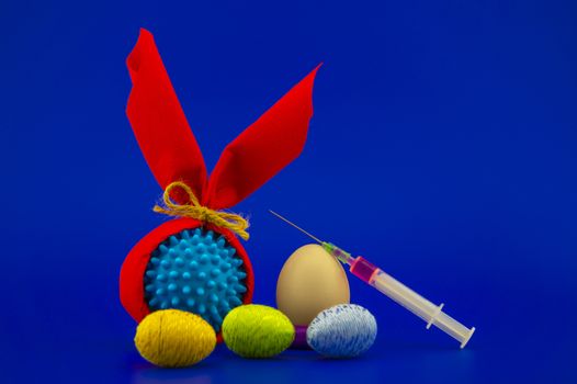 Corona virus models wrapped as gifts and Easter eggs on a blue background with copy space