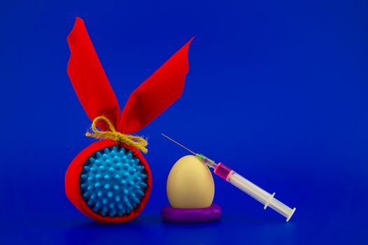 Corona virus models wrapped as gifts and Easter eggs on a blue background with copy space