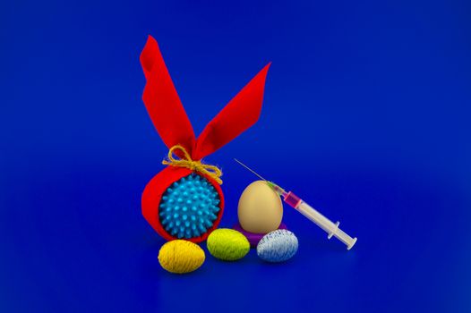 Corona virus models wrapped as gifts and Easter eggs on a blue background with copy space