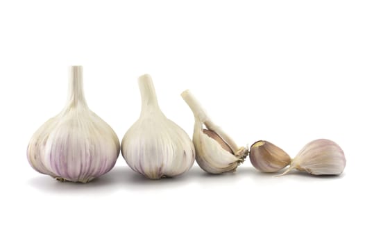 Garlic bulbs and cloves in close-up isolated on white background