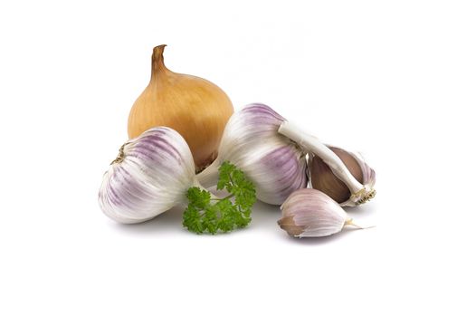 Garlic bulbs and cloves, green parsley twig and golden-brown onion isolated on white background