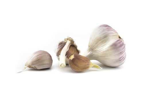 Garlic bulbs and cloves in close-up isolated on white background