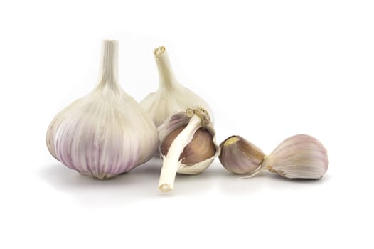 Garlic bulbs and cloves in close-up isolated on white background