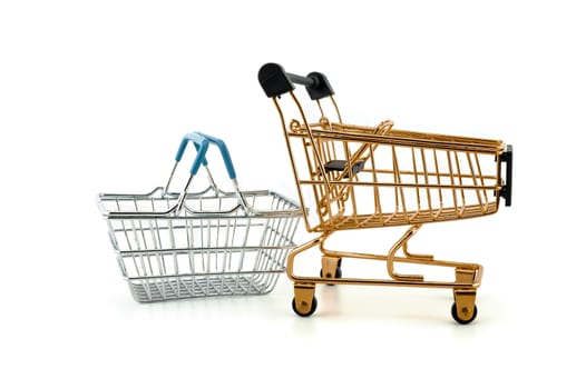 Empty golden shopping cart and wire basket isolated on white background