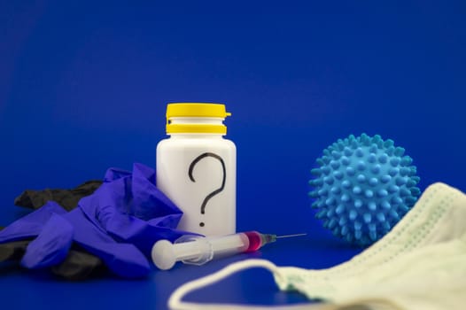 Various medical supplies including a string and face mask with a corona virus model and blue copy space