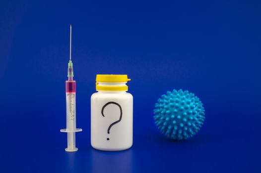 Concept of specific medicine to prevent or treat coronavirus disease with a hypodermic syringe, pharmaceutical bottle and blue virus molecule over a blue background with copy space