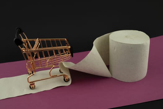 Toilet paper or paper towel and shopping cart over a red banner and dark background