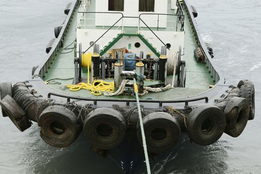 Pilot Boat Attached To Large Ship And Assisting With Navigation Out Of The Port