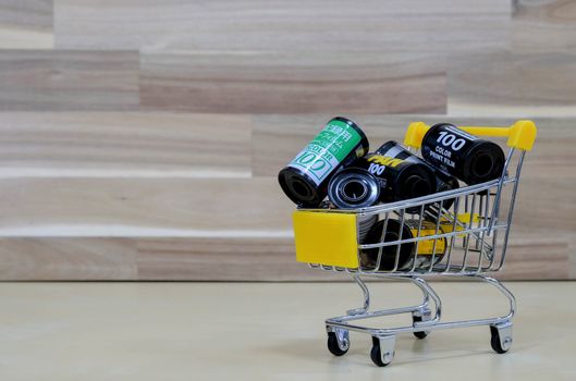 A Group of Film in The Market Cart on Wooden Background