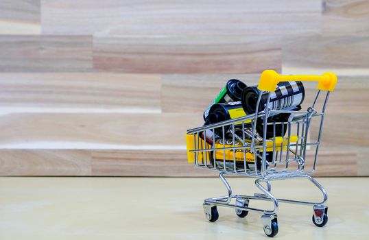 A Group of Film in The Market Cart on Wooden Background