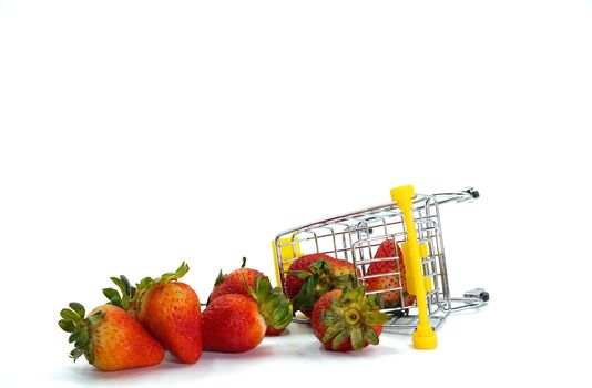 Close up strawberry fall out of shopping cart isolatd on White Background