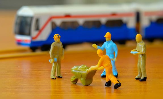 group of miniature Worker meeting to repair The  Train