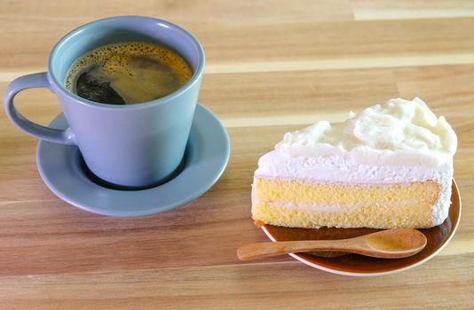 Coconut Cake and a cup of coffee on Wooden table