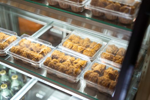 Cake in glass cabinet at cofee shop.