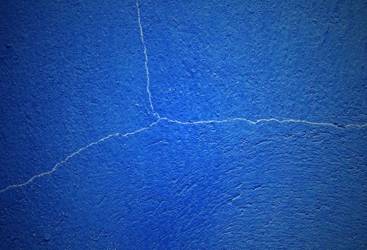 Crack dark blue concrete wall background, vintage and retro style