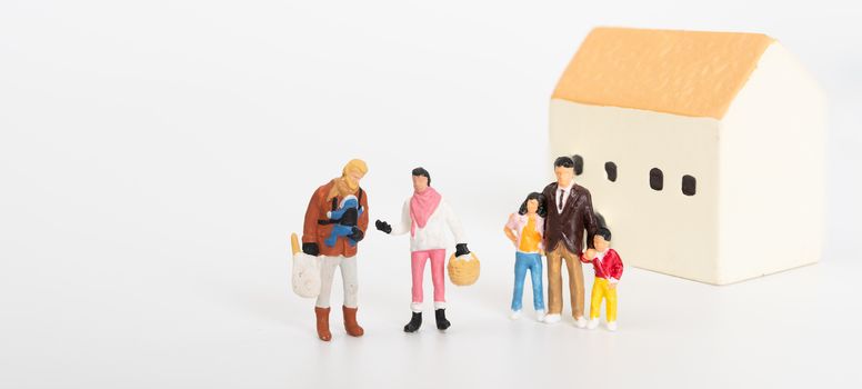 Miniature family people happy with a new house on white background