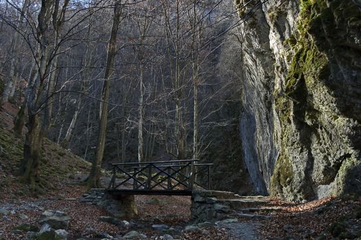 Autumn walk through the maze of Teteven Balkan with high peaks, river, bridge and mossy steep cliff, Stara Planina, Bulgaria