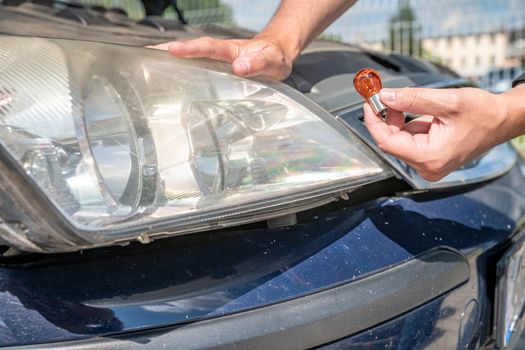 car headlight repair by replacing bad bulbs with new ones.