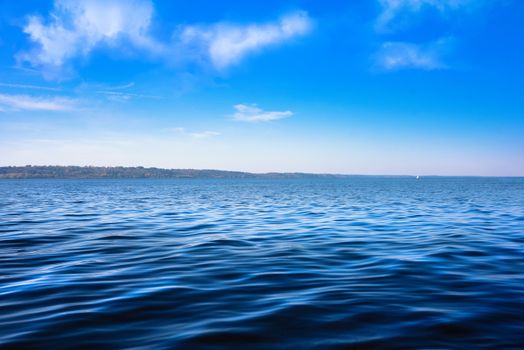 Seascape with sea horizon and almost clear deep blue sky - Background