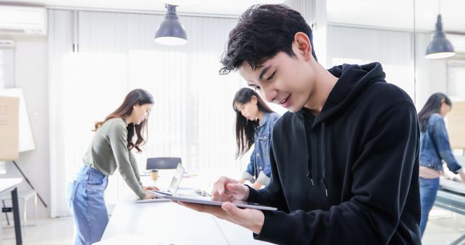 Asian man students use digital tablets to find information for work and study online.