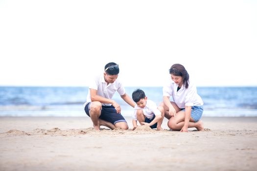 Active parents and people outdoor activity on summer vacations and holiday with children.Happy family and son walk with fun of sunset sea on sand beach.