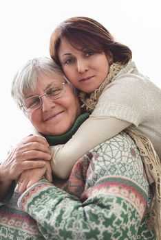 happy senior mother and adult daughter closeup portrait on white