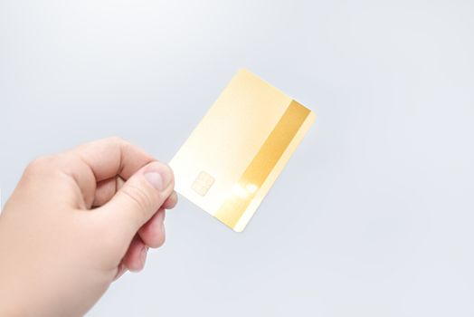 Man holding gold credit card in hand on white background. business concept. credit card payment.