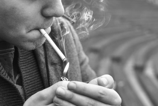 Guy smokes a cigarette outside, portrait, close-up