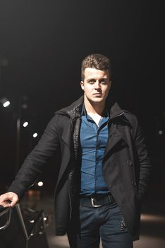 Portrait of well-dressed handsome young man climbing up the stairs