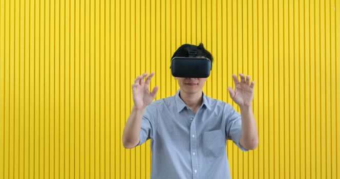 Senior Asian man using tablet and virtual reality simulator playing games in living room and feeling happy . Lifestyle Senior family at home concept.