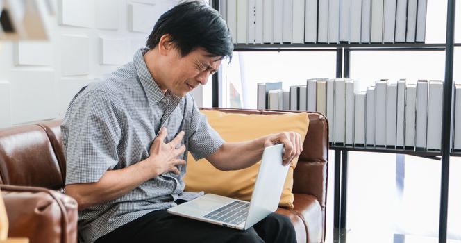 elderly Asian people work hard until they become stressed and he feel bad on his heart