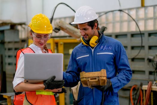 Technician or worker man and woman discussion about robot working in factory. Concept of good system and manager support for better industrial business.