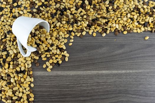Coffee cup scoop Coffee beans that have not yet been roasted on the wooden floor