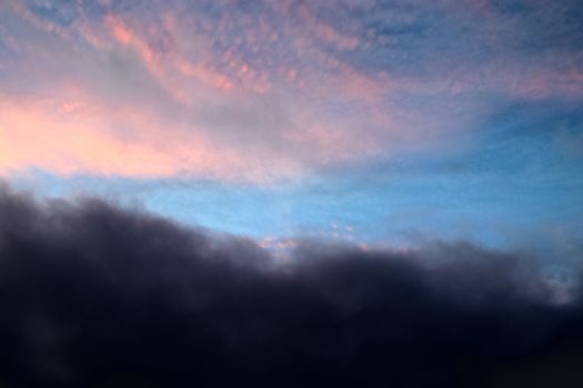 Beautiful panorama of orange and yellow clouds at sunrise and sunset in a blue sky