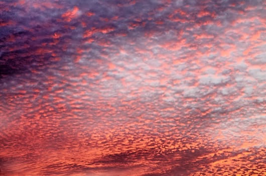 Beautiful panorama of orange and yellow clouds at sunrise and sunset in a blue sky