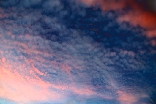 Beautiful panorama of orange and yellow clouds at sunrise and sunset in a blue sky