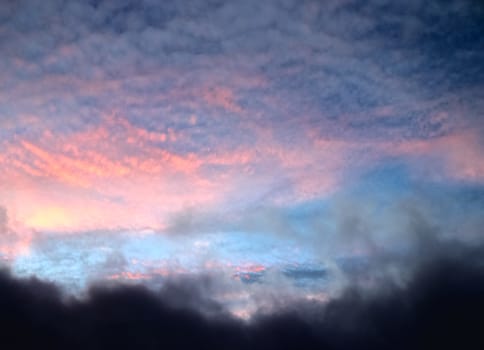 Beautiful panorama of orange and yellow clouds at sunrise and sunset in a blue sky