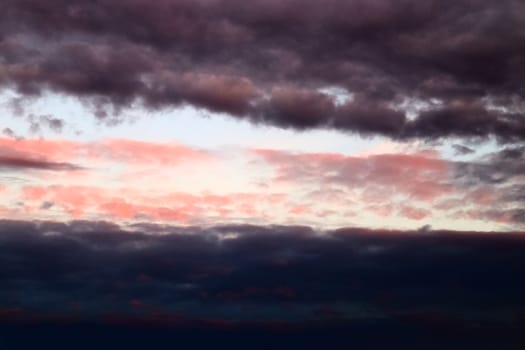 Beautiful panorama of orange and yellow clouds at sunrise and sunset in a blue sky