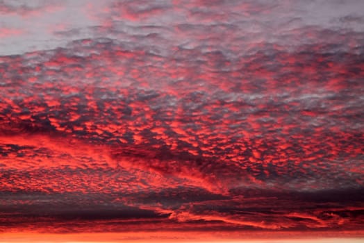 Beautiful panorama of orange and yellow clouds at sunrise and sunset in a blue sky