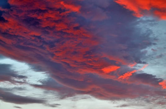 Beautiful panorama of orange and yellow clouds at sunrise and sunset in a blue sky